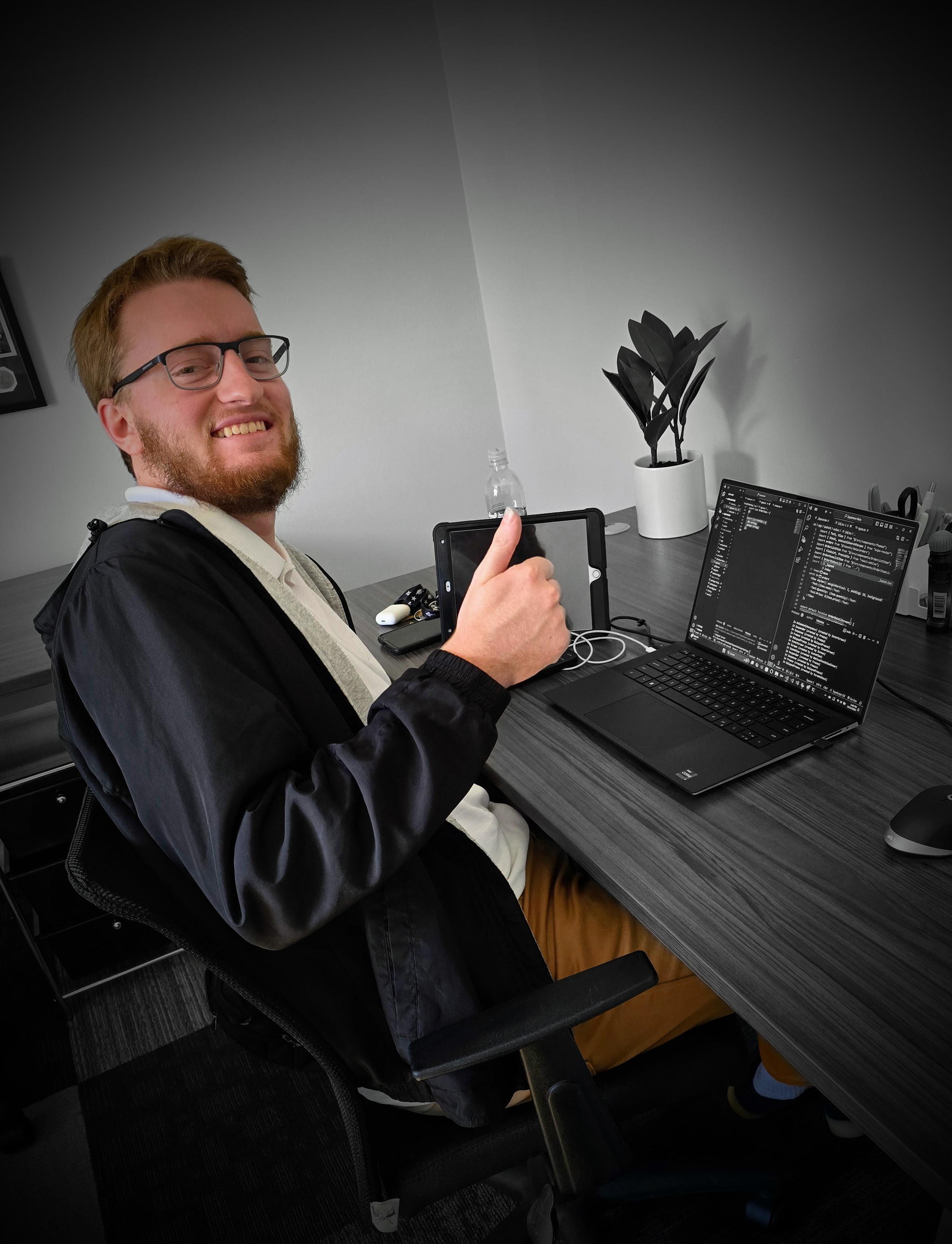 Professional developer working on website development with code visible on laptop screen